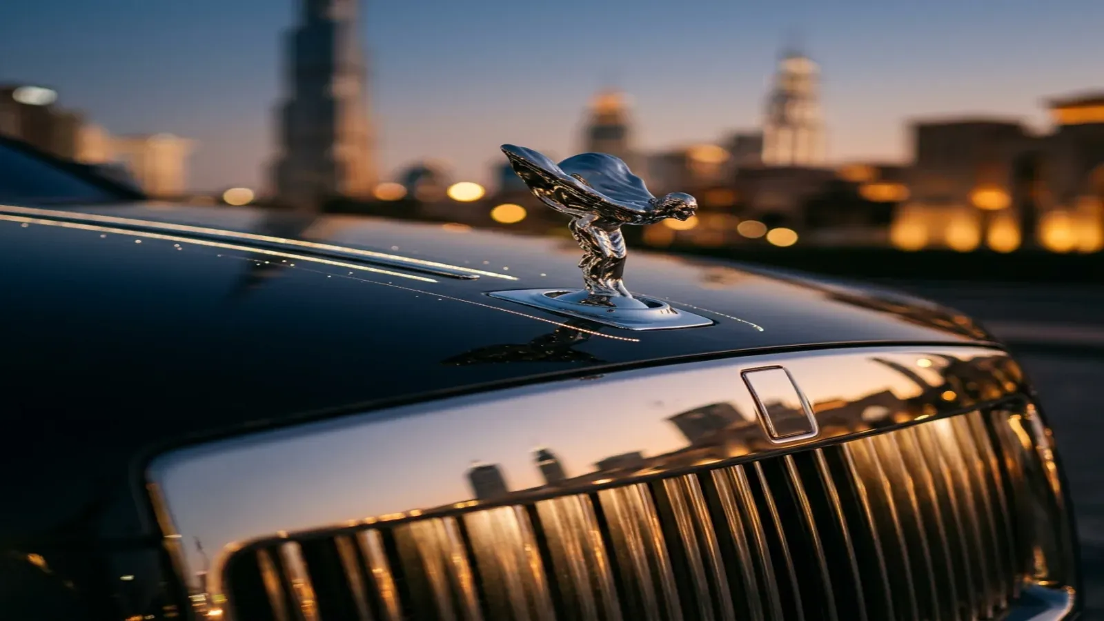 Элегантный белый Rolls-Royce Ghost припаркован возле набережной Дубай Марина на фоне футуристических небоскребов.