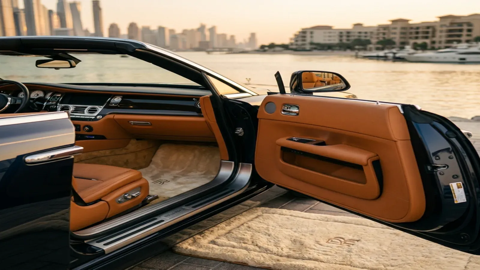 A modern Rolls-Royce Ghost cabin showing the digital dashboard and hand-crafted wood veneers in Dubai