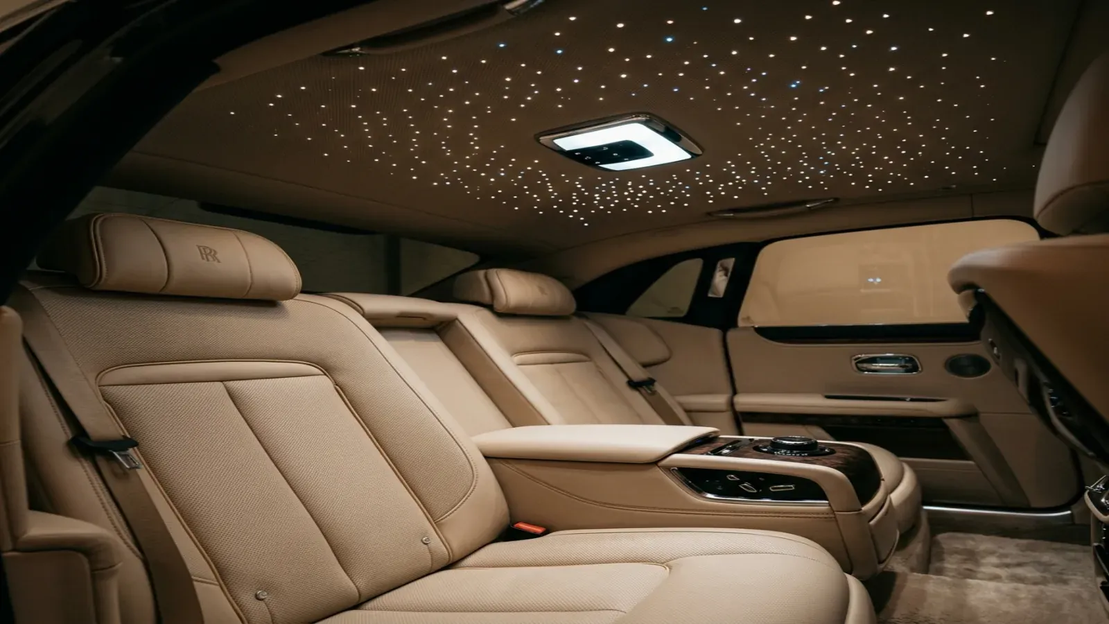 A Rolls-Royce Ghost parked in Dubai at blue hour showing the Spirit of Ecstasy