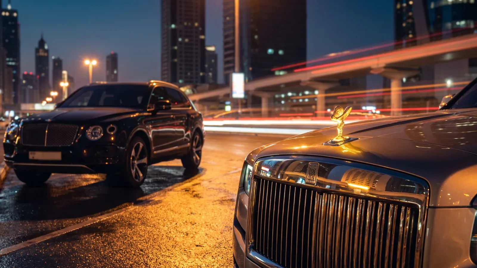 Rolls-Royce Cullinan and Bentley Bentayga on Sheikh Zayed Road at blue hour in Dubai.