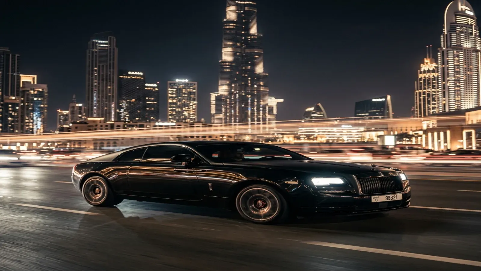 Rolls-Royce Wraith Black Badge driving through Dubai Marina at night